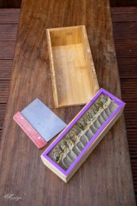 Freshly poured soap in mould with soap cutter on the table – handcrafted soap making process in Midlothian