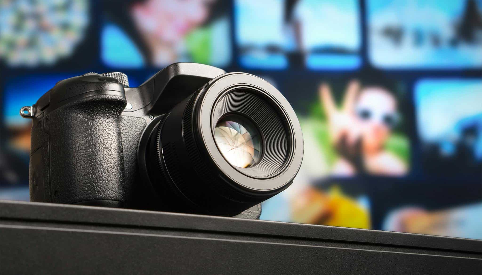 Close-up view of a DSLR camera lens with visible aperture and blurred background.