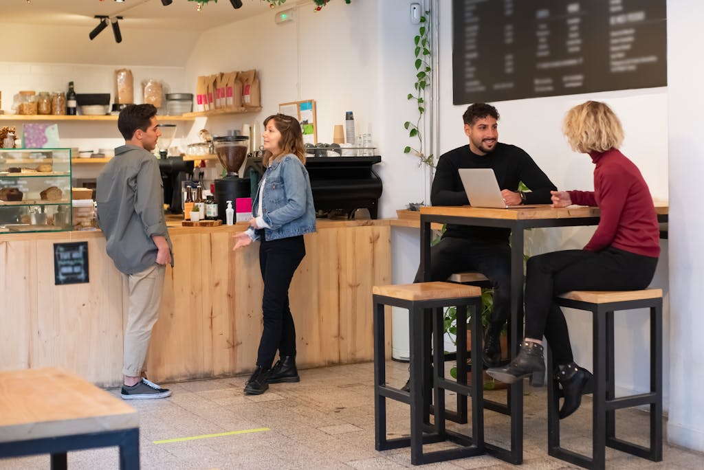 People interacting in a cozy Portuguese café, sharing conversations and drinks.